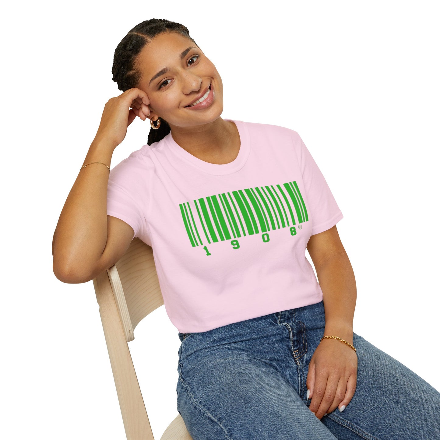 Smiling woman wearing a pink t-shirt with a green barcode design featuring '1908,' symbolizing Alpha Kappa Alpha Sorority® legacy and sisterhood.