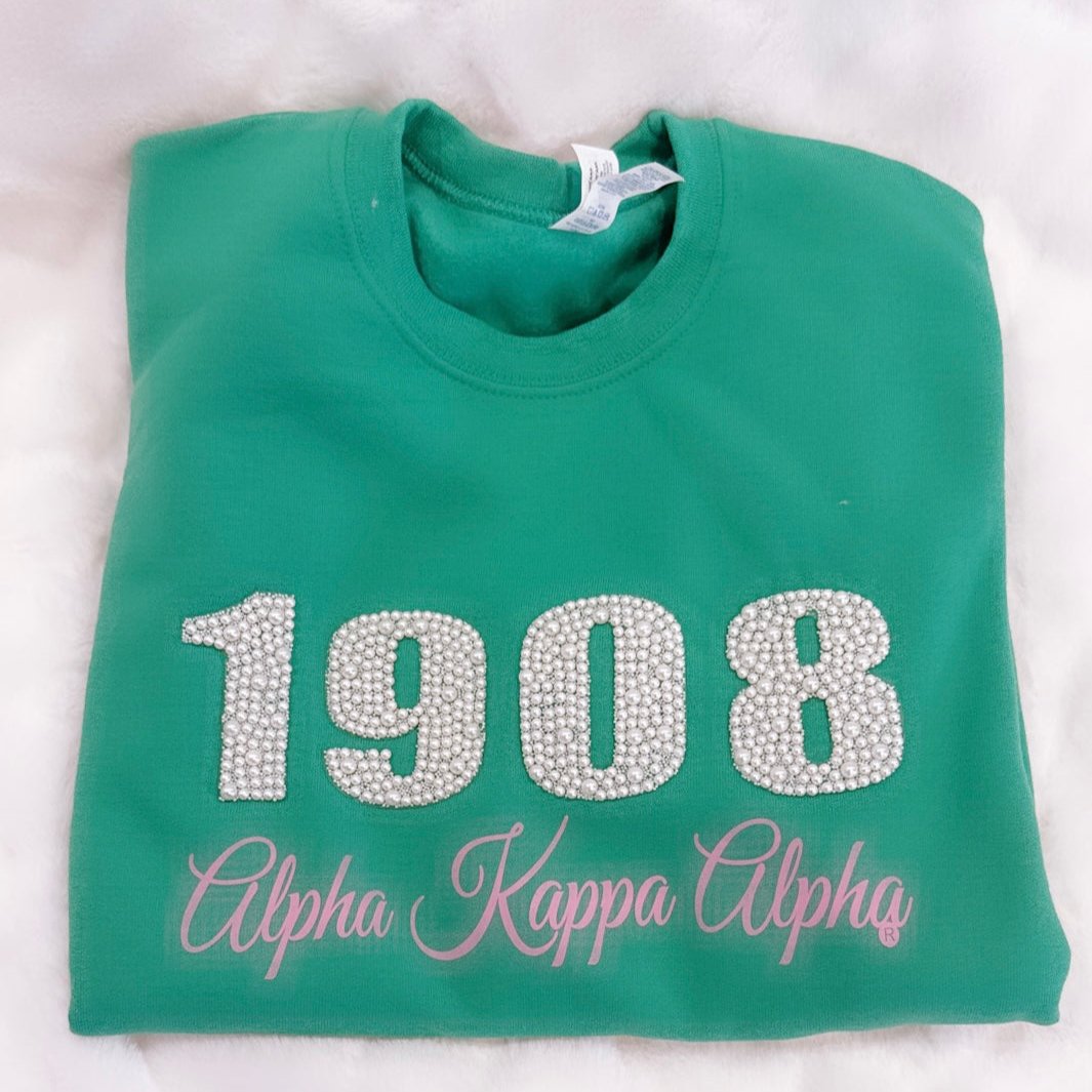 "Green unisex sweatshirt featuring '1908' in pearls and 'Alpha Kappa Alpha' in coordinating green lettering, perfect for members of Alpha Kappa Alpha Sorority, Inc., to display their pride in style and comfort."