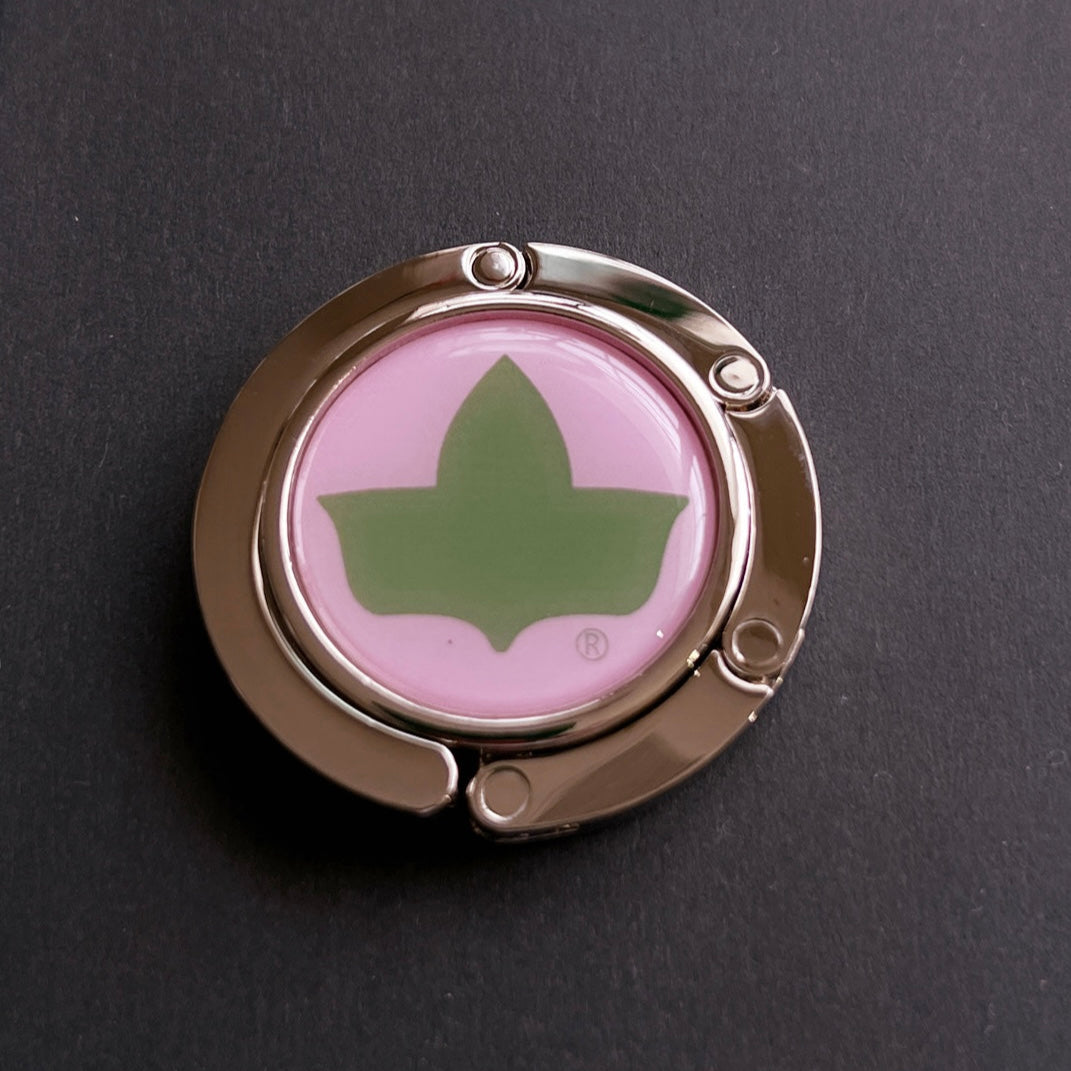 Alpha Kappa Alpha® purse hanger with official green Ivy Leaf on pink background and silver folding hook