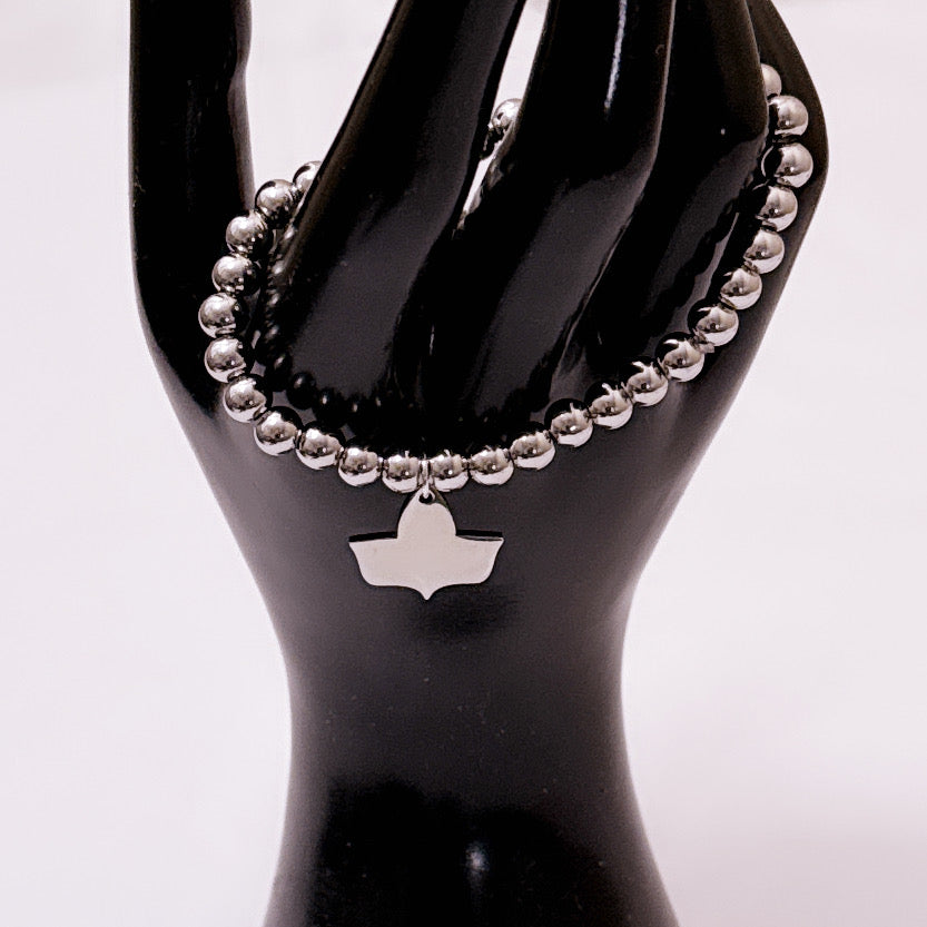 Stainless steel beaded stretch bracelet with official Alpha Kappa Alpha Ivy charm displayed on a black mannequin hand.