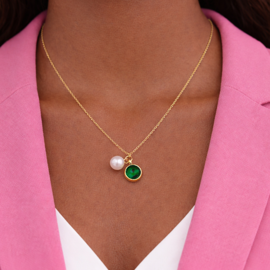 Gold plated stainless steel necklace with emerald green crystal charm and pearl accent on adjustable chain