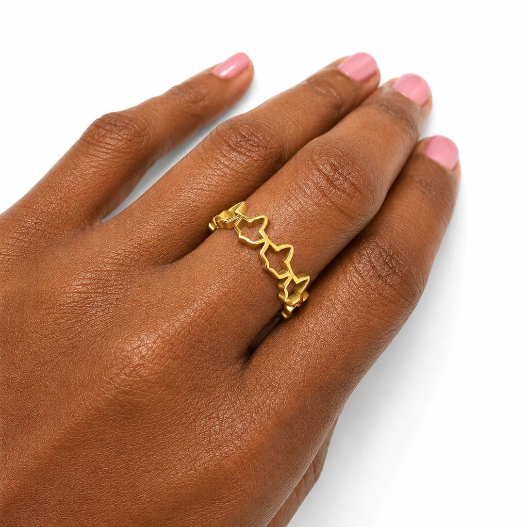 Gold stainless steel ivy ring worn on hand with glossy pink nails, featuring an elegant open ivy band design on a clean white background.