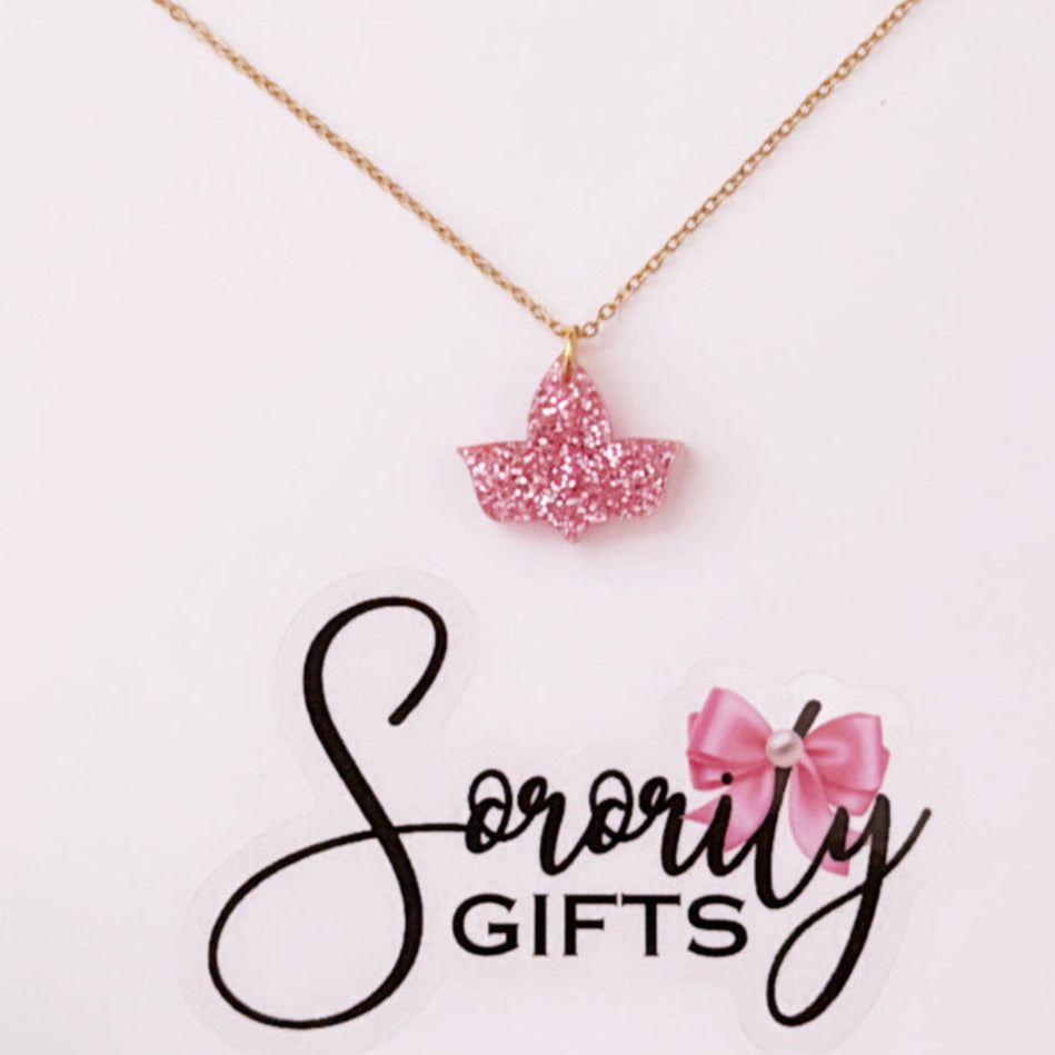 Pink glitter ivy leaf pendant necklace with a gold chain, displayed on a white backing card with the "Sorority Gifts" logo featuring a pink bow.