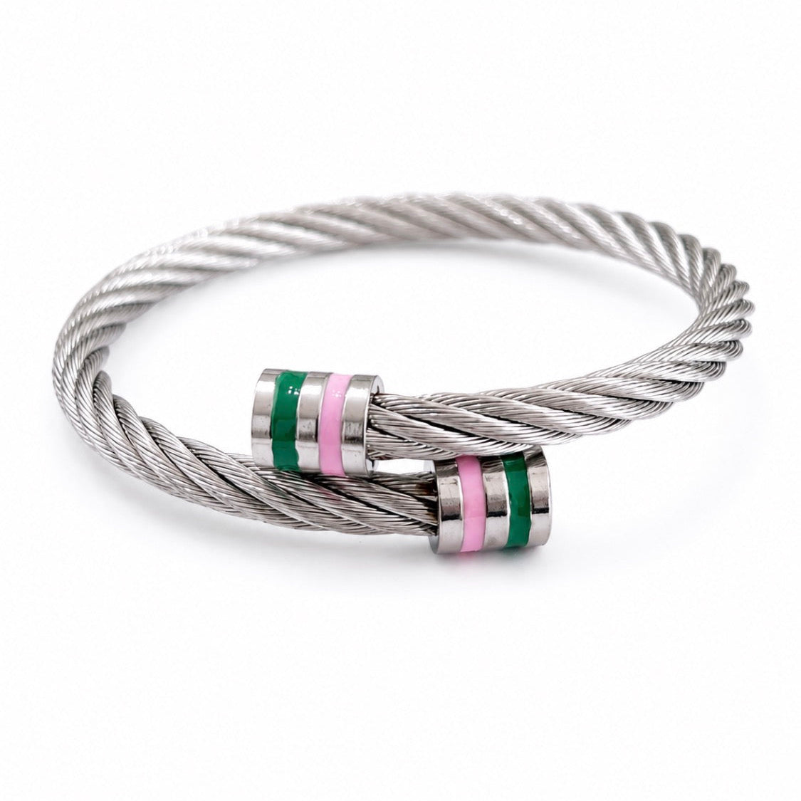 Adjustable stainless steel cable bracelet featuring a twisted silver design with pink and green enamel accent bands, displayed in a white gift box.