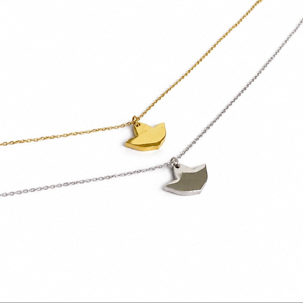 Gold and silver ivy leaf pendant necklaces with delicate chains displayed on a white background.