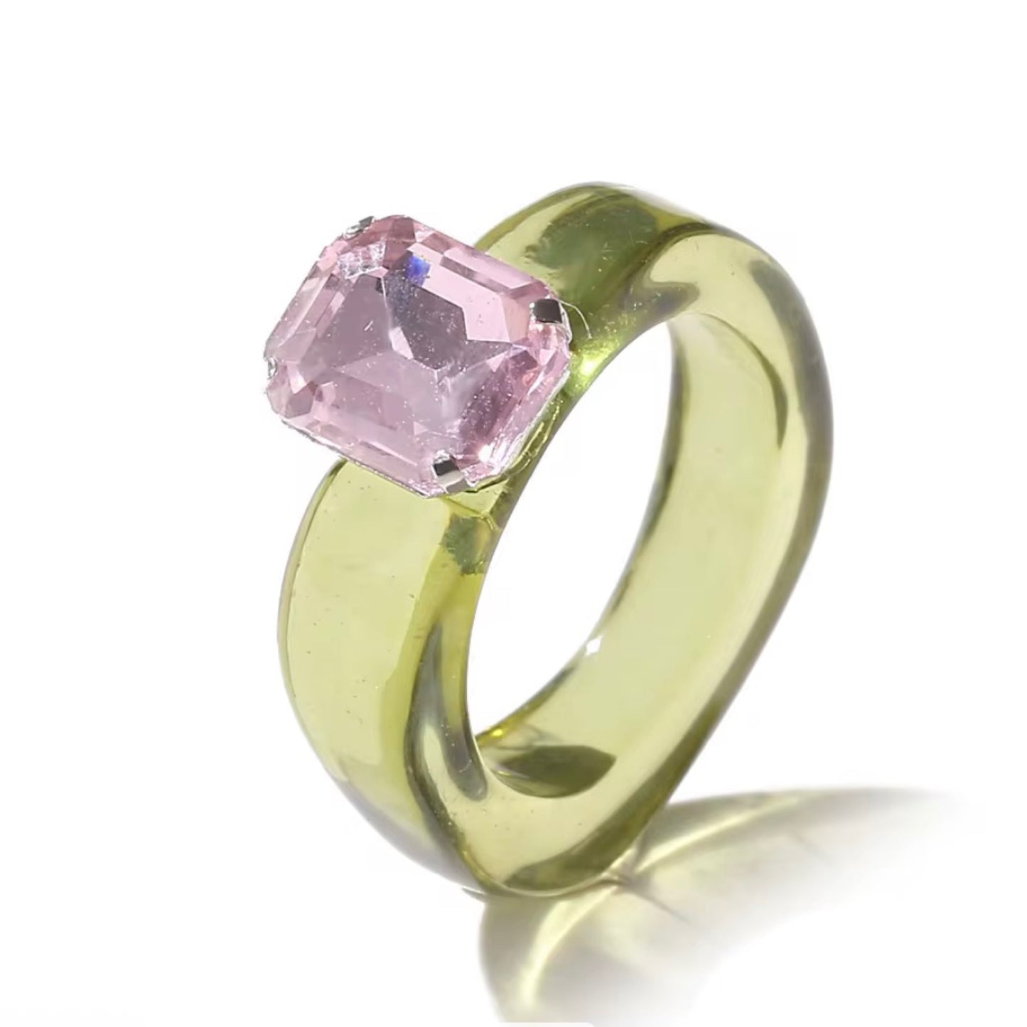 Gold ring with a pink gemstone on a white background