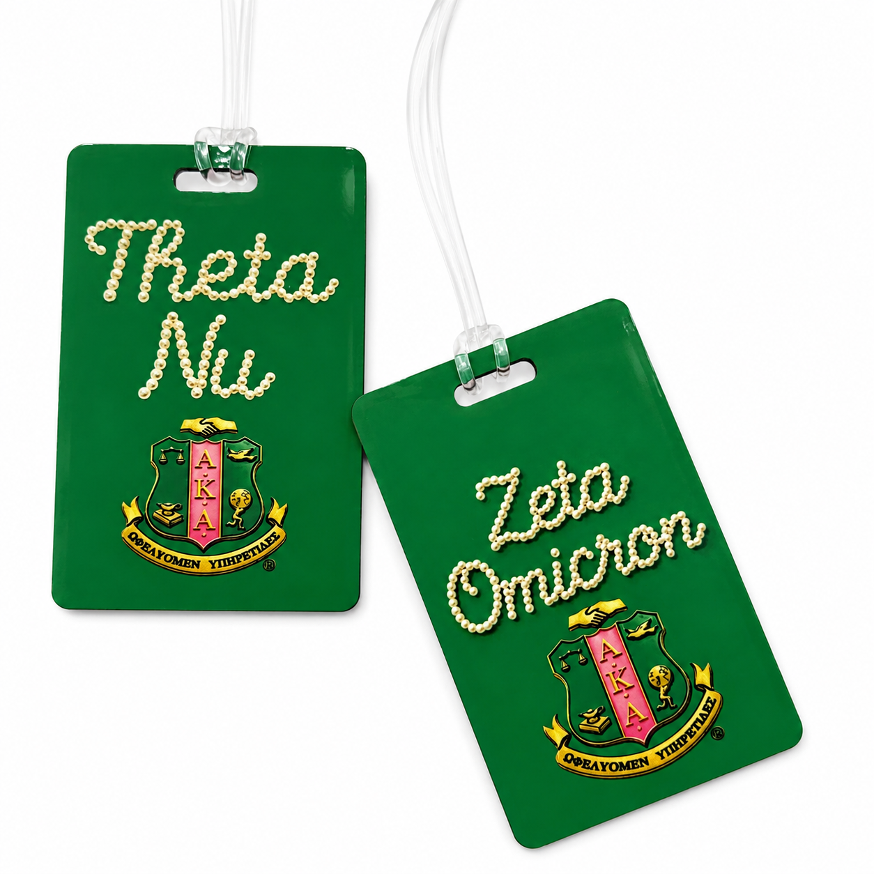 Two green luggage tags with white cords, featuring Greek lettering and fraternity crests. One tag reads 'Theta Nu' and the other reads 'Zeta Omicron' above matching crests, shown on a white background.