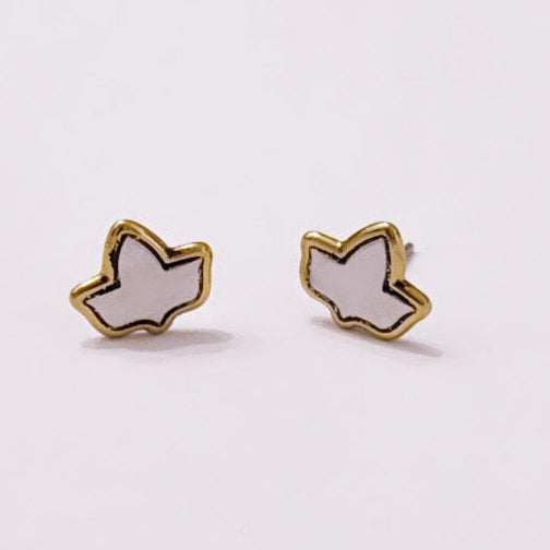 Pair of two toned Ivy shaped earrings on a light gray background.