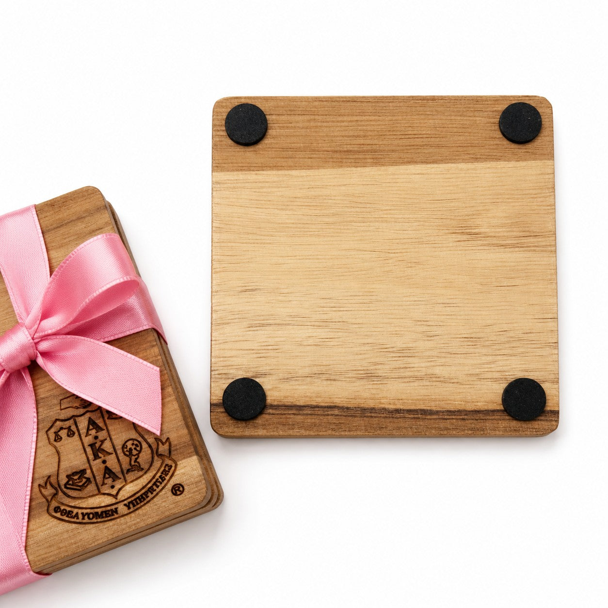 Bottom view of an Alpha Kappa Alpha Sorority, Inc.® engraved 4 x 4 inch acacia wood coaster featuring four non-slip silicone dots for surface protection and stability. Natural wood grain makes each coaster unique.