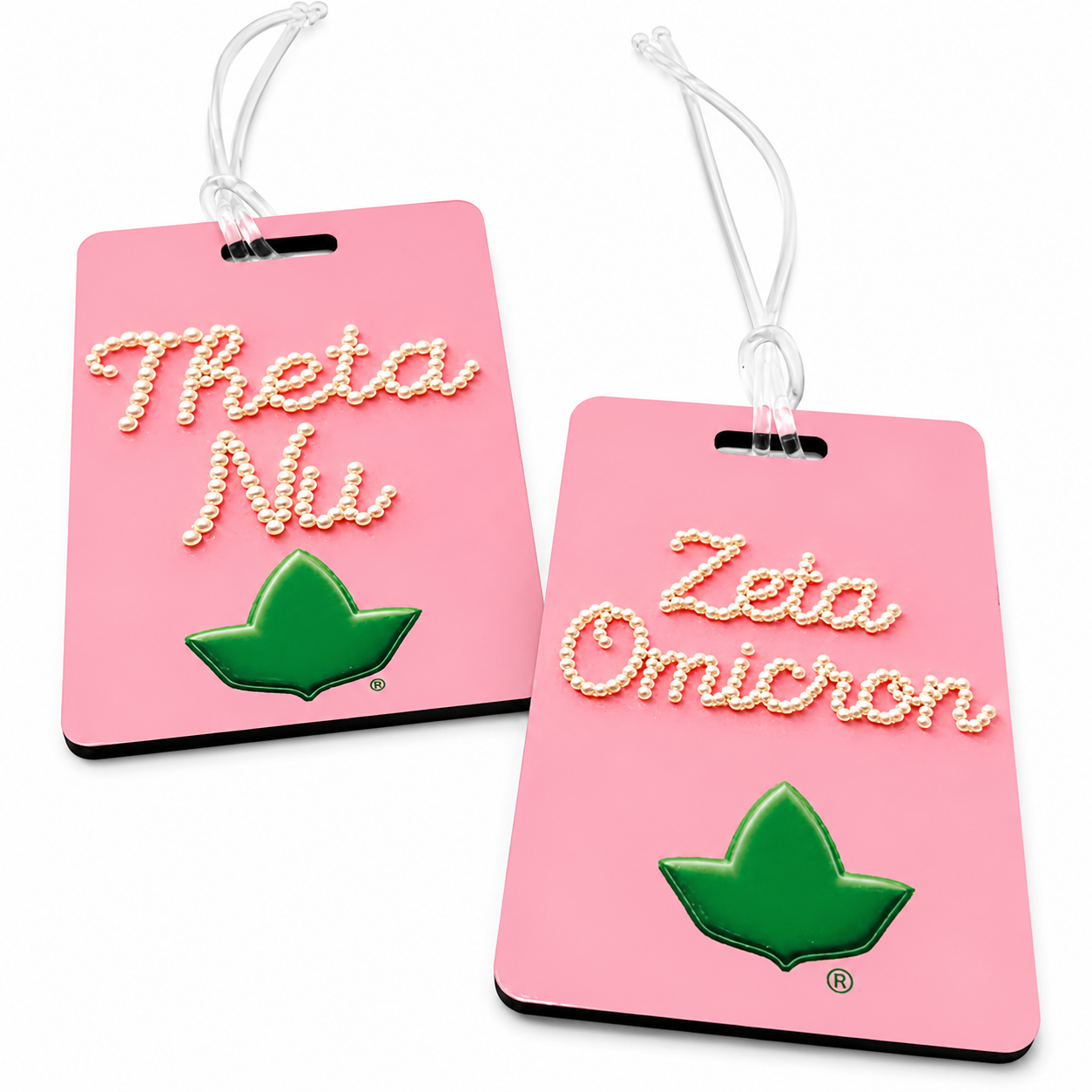 Personalized pink chapter luggage and purse tags featuring Theta Nu and Zeta Omicron with pearl lettering, green ivy emblem, and clear luggage loop on a white background.