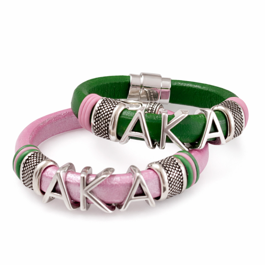 Pink and green Alpha Kappa Alpha AKA leather bracelets with silver letter charms displayed on a white background