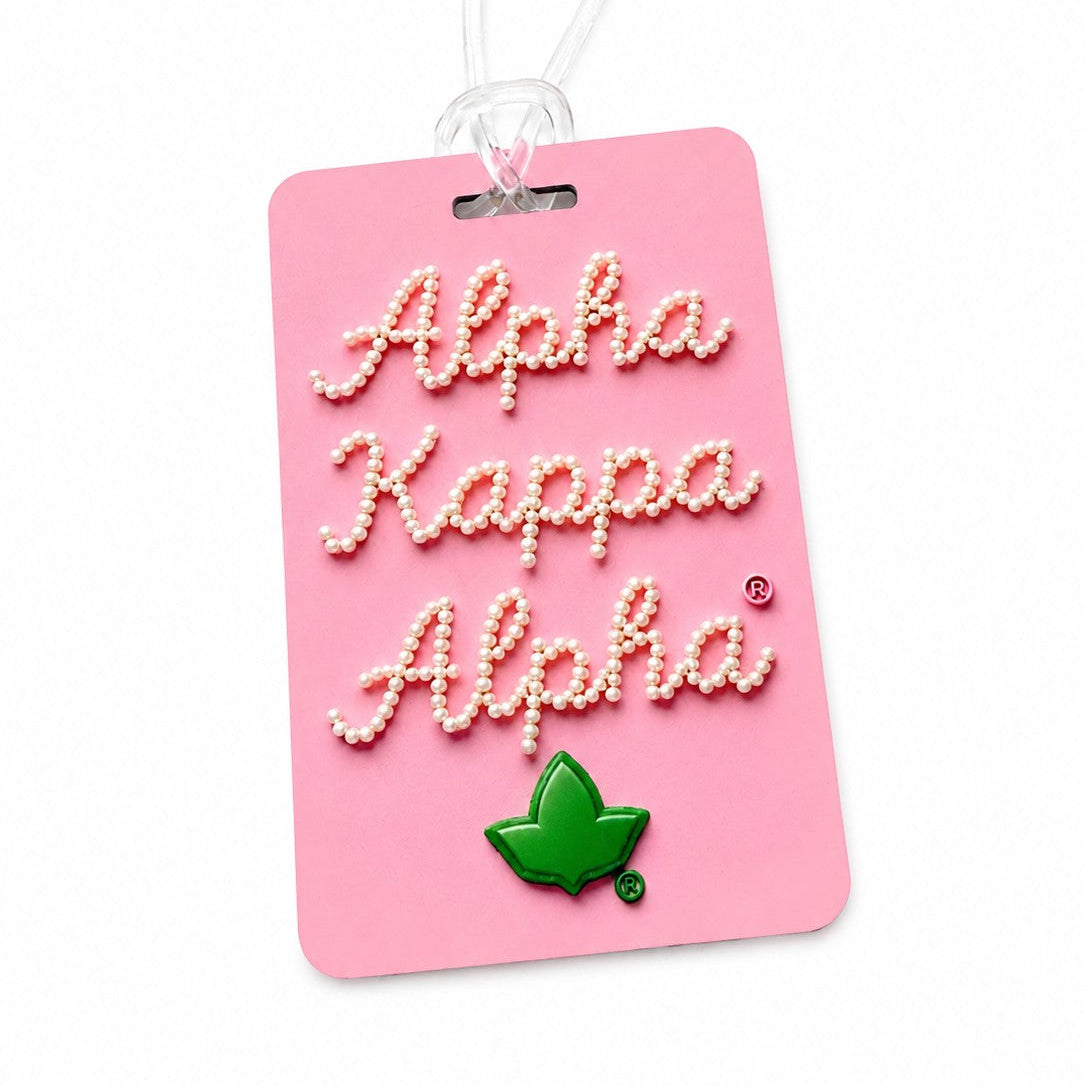 Double sided Alpha Kappa Alpha Pretty Nice purse and luggage tag in pink with green ivy leaf design, pearl lettering, durable board construction, and clear travel strap.