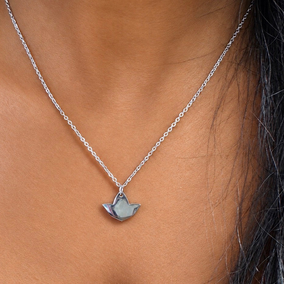 Model wearing a dainty silver ivy leaf pendant necklace with a delicate matching chain.