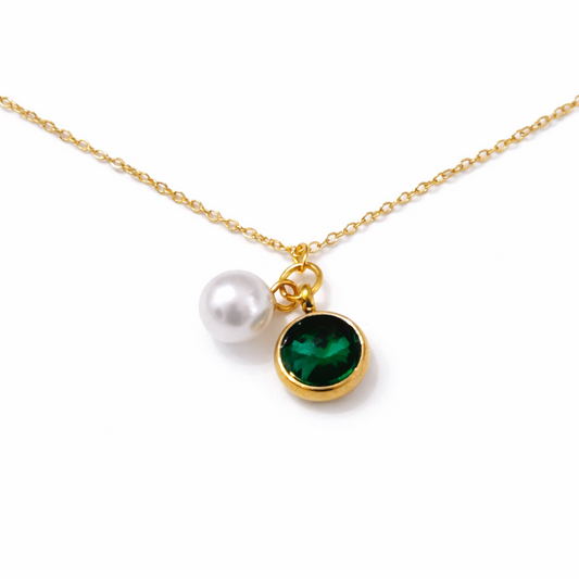 Gold necklace featuring a white pearl charm and a green round gemstone pendant displayed on a clean white background.