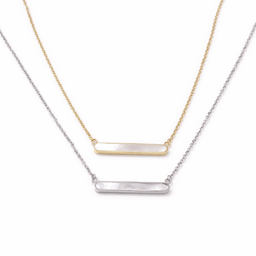 Gold and silver pearl bar necklaces displayed together showing finish options