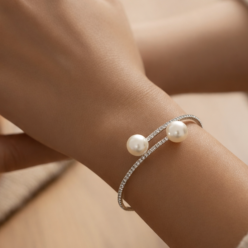 Open pearl cuff bracelet with crystal band worn on wrist, elegant silver pearl bracelet on model