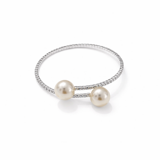 Silver open cuff bracelet with double pearls and crystal band on white background