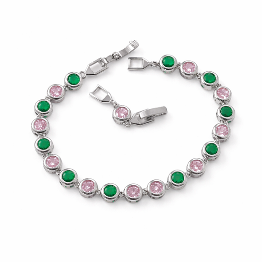 Silver  Tennis Bracelet with alternating pink and green round gemstones arranged in a full circle on white background