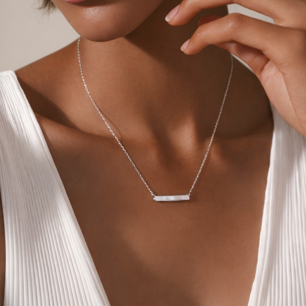 Silver pearl bar necklace in stainless steel with minimalist bar pendant on white background