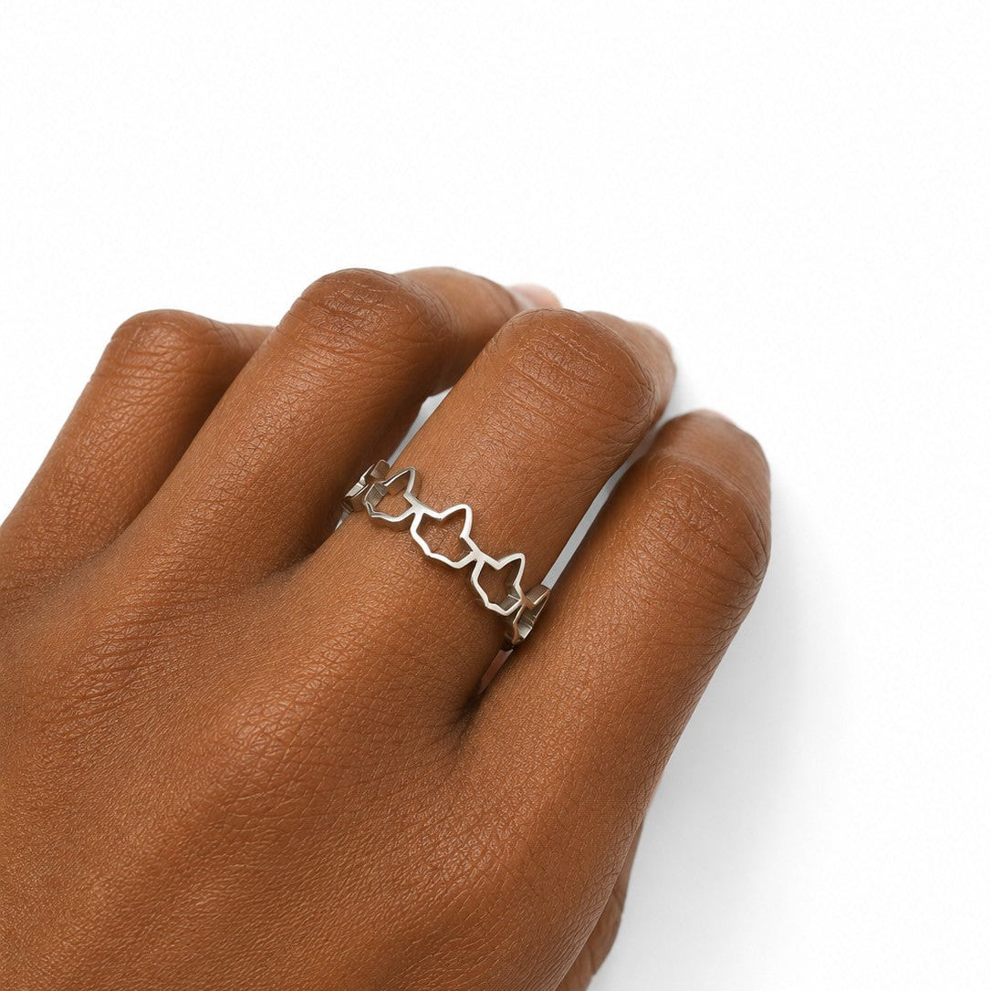 Silver stainless steel ivy ring worn on hand featuring an elegant open ivy band design, showcasing a minimalist everyday ring on a white background.