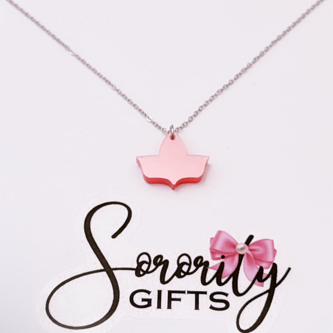 Solid pink ivy leaf pendant necklace displayed on a white card with the "Sorority Gifts" logo featuring a pink bow.