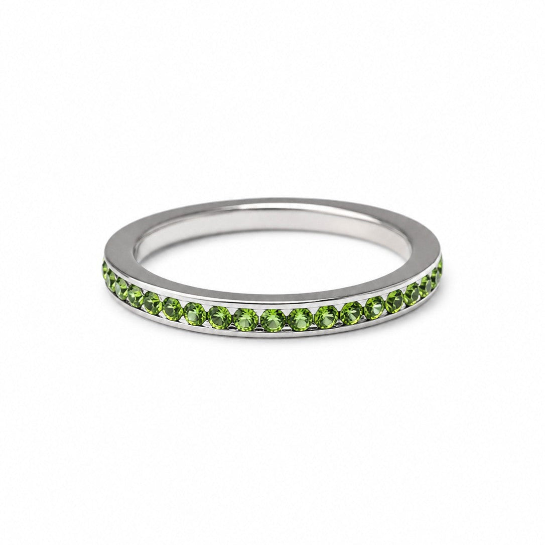 Stainless steel stacking ring with green cubic zirconia stones on a white background, featuring a slim, minimalist design for everyday wear and layering