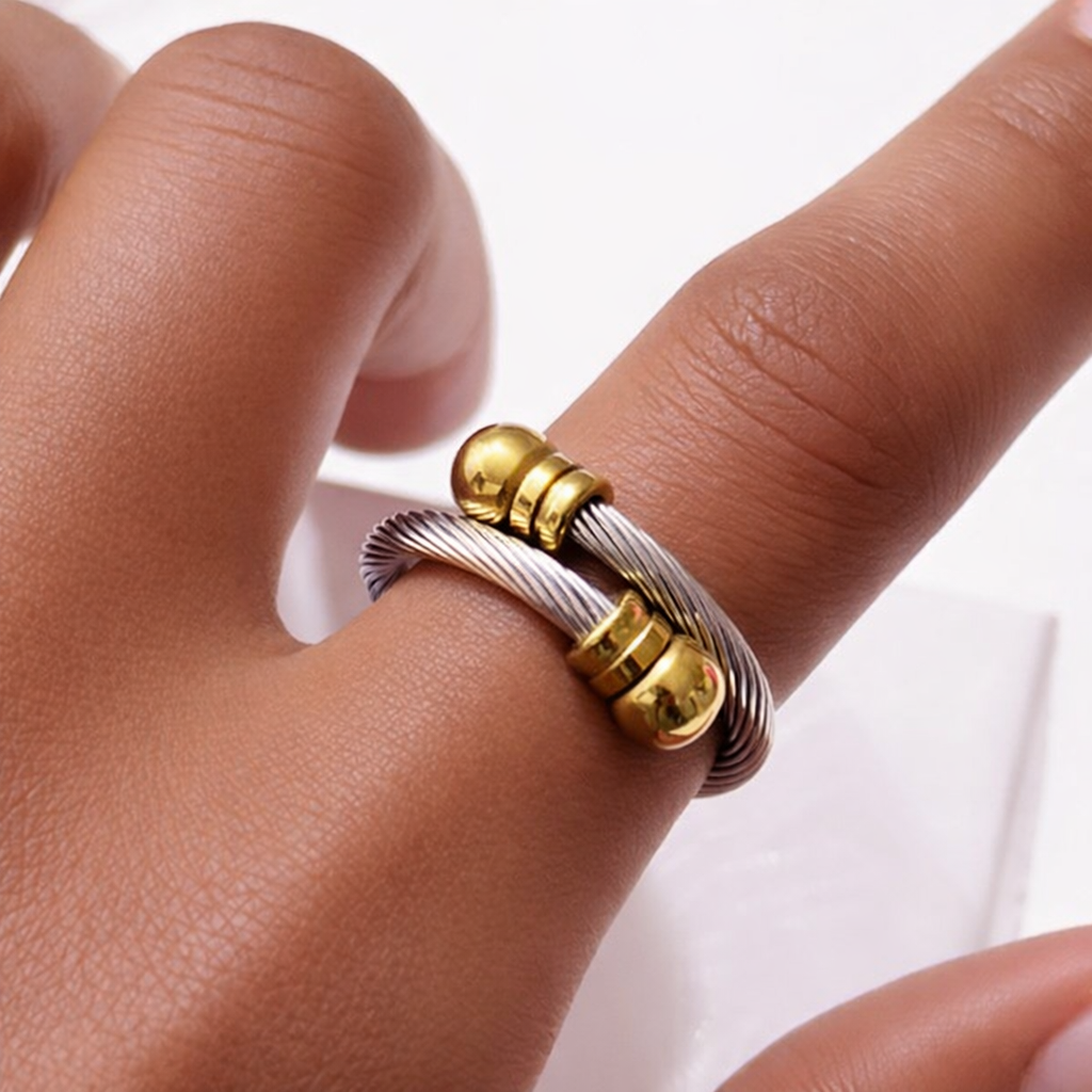 Two-tone stainless steel adjustable ring modeled on finger showing cable detail